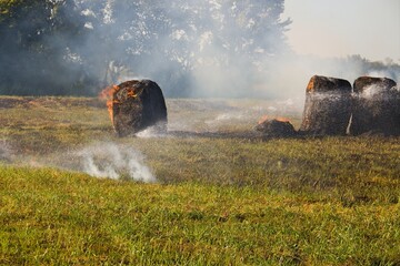 The grass fire moved into the hay bales  © SnapWild Photogrpahy
