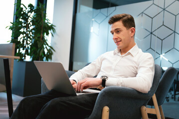 Businessman working on a laptop in a modern office