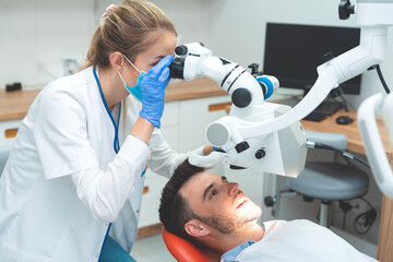 Dentist examination patient with microscope