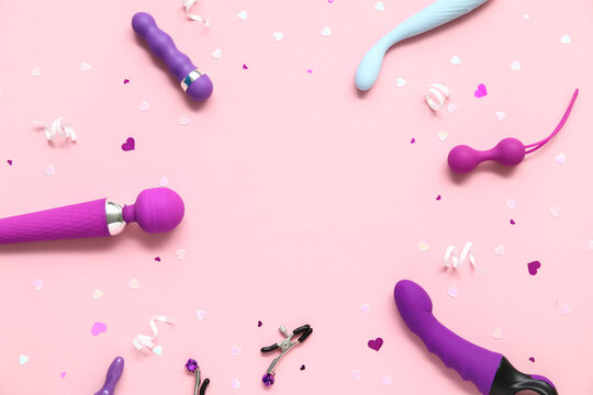 Frame made of different sex toys on pink background
