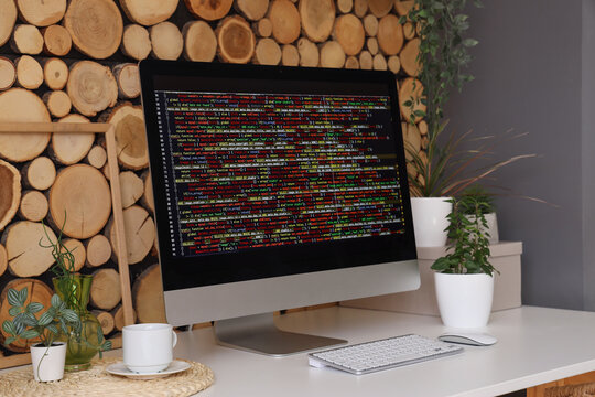 Stylish workplace of programmer with modern computer in light office