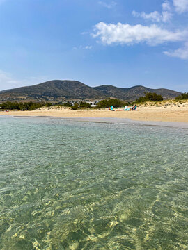 Beach with Clear Blue Water and Large Distant Mountains on Paros Island, Greece