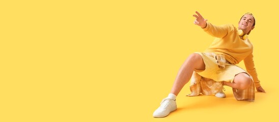 Obraz premium Stylish young man on yellow background with space for text