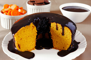 Brazilian Carrot Cake with Chocolate Frosting, cut in half, on a pastry table