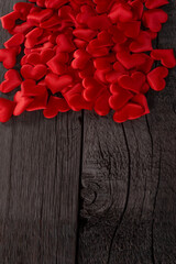 Red Hearts Scattered on Wooden Background Symbolizing Love and Passion. Valentines Day and Love Wallpaper Background.