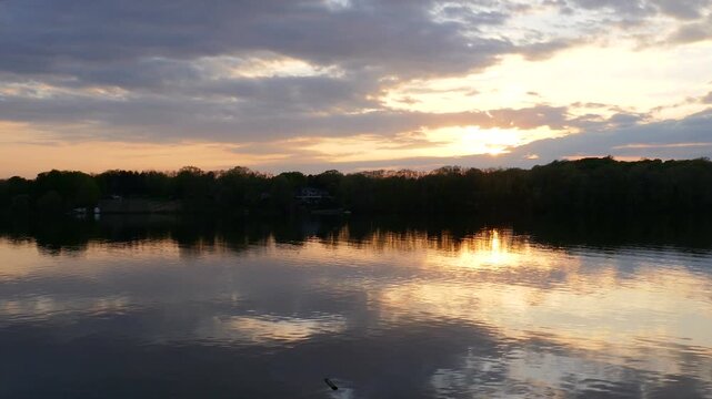 Sunset during early spring on Lake Chapin in southwest Michigan, United States. Evening over the water in rural America.