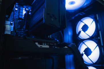 Side view of PC chassis with illuminated fans and heatsink, airflow concept and powerful hardware