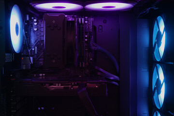 Modern gamer computer interior with purple and blue RGB lighting, advanced technology and professional gaming concept