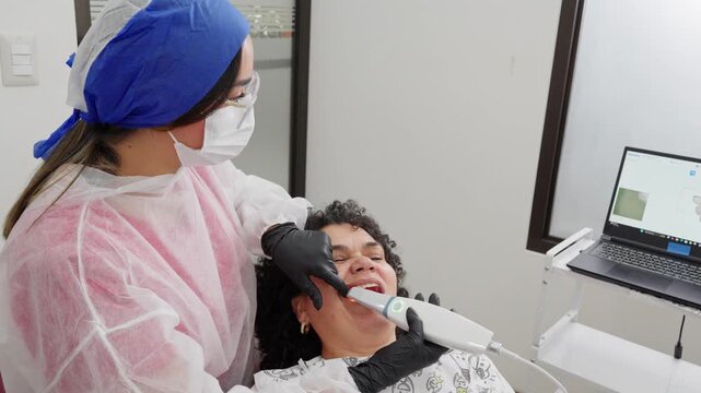 Dentist using an intraoral 3d scanner on a patient's mouth