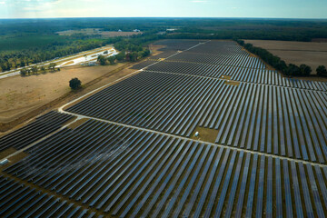 Aerial view of big sustainable electric power plant with many rows of solar photovoltaic panels for producing clean electrical energy. Renewable electricity with zero emission concept