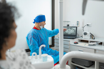 Fototapeta premium Dentist explaining dental x-ray to patient in clinic