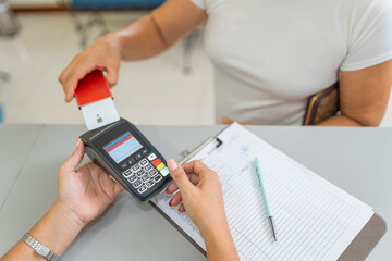 Close up of a customer paying with a credit card at a terminal
