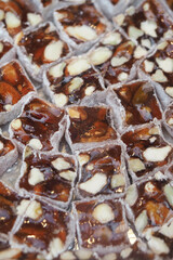 Candied nuts in square blocks on a tray in the market