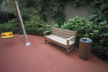 Wooden bench and swing set in a playground area