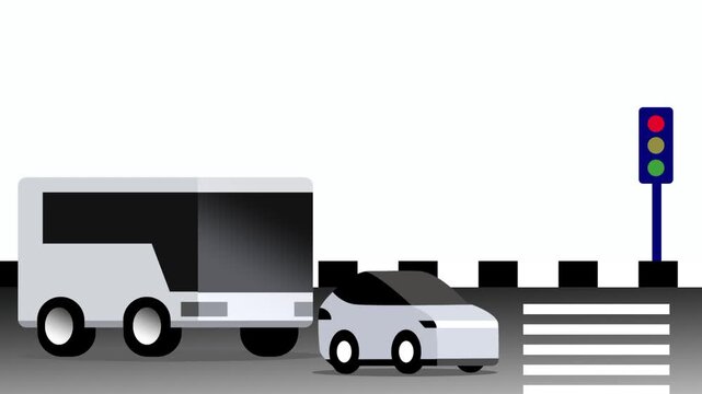 A grey bus and a small car are stopped at a street intersection with a green traffic light to show a common urban transportation scene