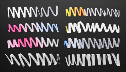 Assortment of abstract, scribbled, wavy, and spiraling lines in various colors on a black background