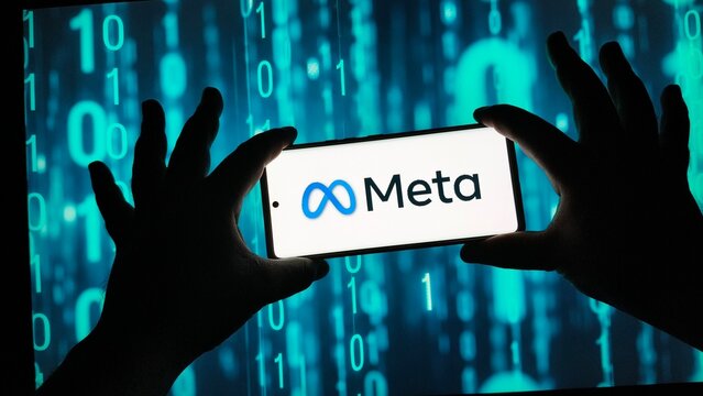 Hands holding smartphone with Meta logo on screen
