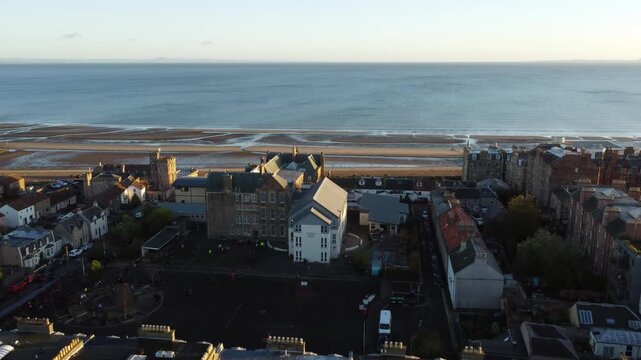 Flying from the waters edge into the town of Portobello Scotland drone view