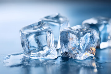 Obraz premium Clear ice cubes stacked on a dark surface in a cool setting during evening hours