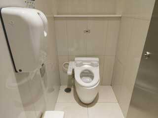 Clean Modern Bathroom Interior with Toilet and Hand Dryer Features