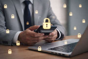 Businessman using smartphone and laptop with digital lock icons representing mobile security data protection online authentication and cybersecurity technology concept