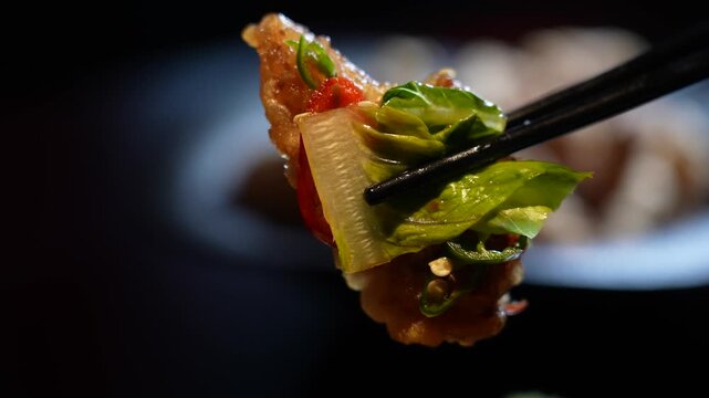 Chopsticks picking up yuringi with vegetables