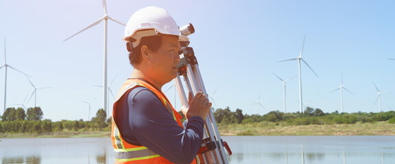 Technicians are using a surveying instrument to measure the distance of a road construction project...