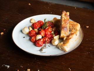 roasted cherry tomato with garlic and rosemary, served with focaccia breadsticks