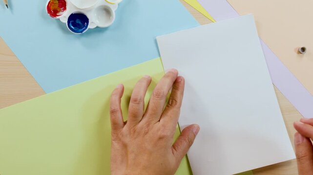 Creating a Symmetrical Paint Blot Art Piece on White Paper