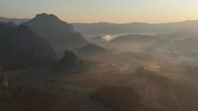 An aerial view of the forest and mountains in a misty morning at Pha Chai Noi, Thailand.