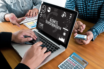 Team collaboration on laptop displaying digital business transformation strategy graphic