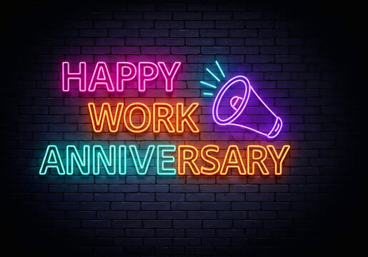 Neon-style text on a dark brick wall reads "Happy Work Anniversary" in pink, orange, and blue, with a megaphone graphic symbolizing celebration.