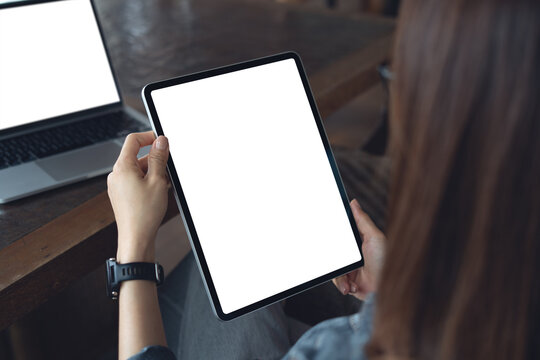 Mockup blank screen digital tablet, woman hands holding tablet with empty screen for online marketing or mobile app design. Business woman online working at office, closeup - Powered by Adobe