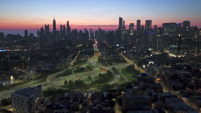 Drone circling the interchange on Kennedy Expressway, dusk in West Town, Chicago