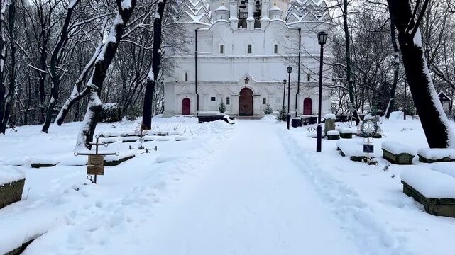 A 16th-century temple with an adjacent cemetery in winter