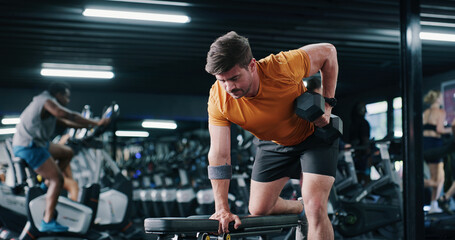 Fitness, man and exercise with dumbbell row in gym for muscle development, power and energy....