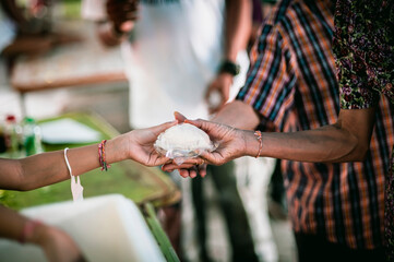 The hand of a beggar received food from a compassionate person, Concept of sharing