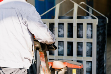 The workers are loading the truck with a forklift.