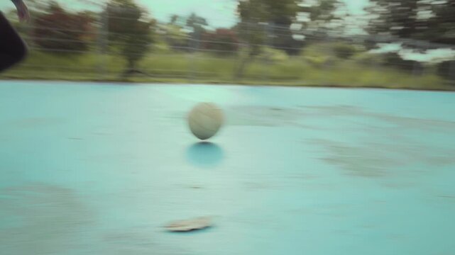 Asian girl playing futsal football outdoor.