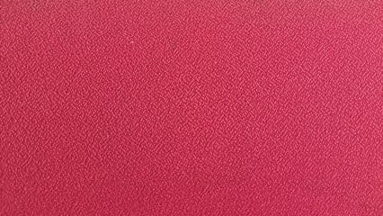 Fototapeta premium Textured pink surface, a vibrant and solid color backdrop for creative projects and design inspiration