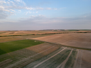 Bergnicourt, Rethel, Ardennes, Grand-Est, France, August, 28th, 2025, A vast and expansive landscape filled with rich farmland in various shades of green and brown beneath a clear sky