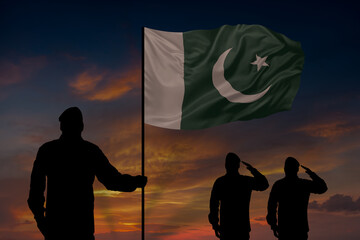 Military mans holds in their hands National flag of Pakistan