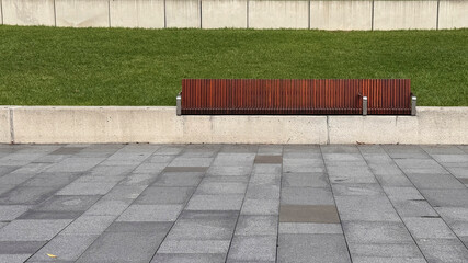 empty wooden bench built on retaining wall in the park