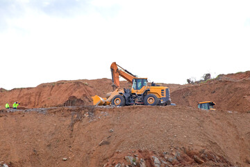 Obraz premium Dozer or excavator on the construction site. Deforestation or urbanization. Massacre of nature, environmental disaster. Heavy construction vehicles concept. 