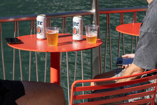Chicago, IL, USA - Aug 28, 2025: Enjoying a Miller Lite, an American-style pilsner and a light lager, at the riverwalk along the south bank of the Chicago River in downtown Chicago, Illinois.