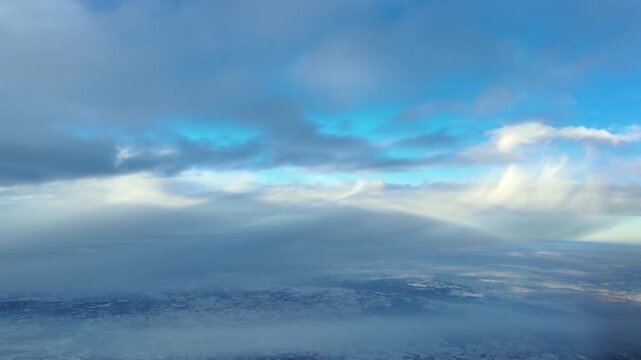 Pilot&rsquo;s Eye POV Flying Through Snow Clouds, with Snowfall Vivible in the Distance. Cockpit View Approaching to Munich Airport (MUC).