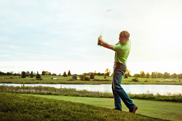 Golf course, swing and man with fitness, competition and wellness with lake, space and training. Outdoor, golfer and person with routine, practice and technique with game, athlete and sports club