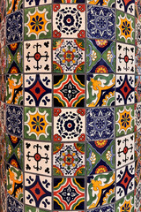 colourful handmade mosaic tiles on a column indoors