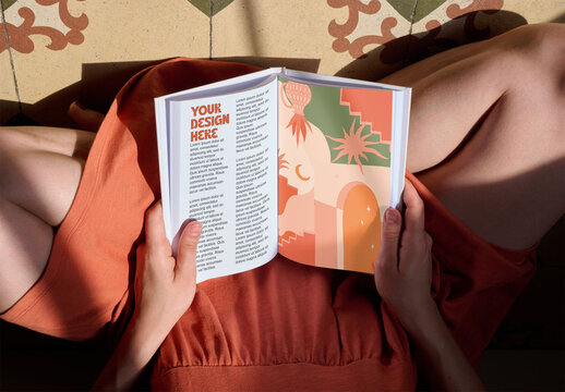 Mockup of an open book. Overhead of two book pages held by an anonymous woman.