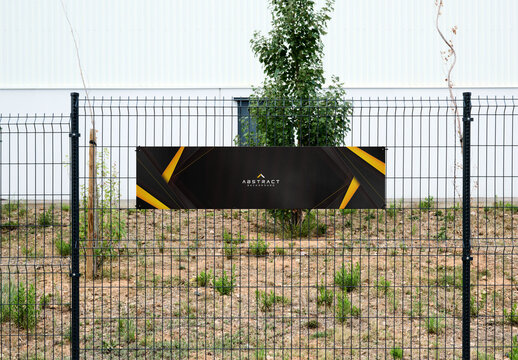 Mockup of A red sign hangs using cable ties on a metal fence